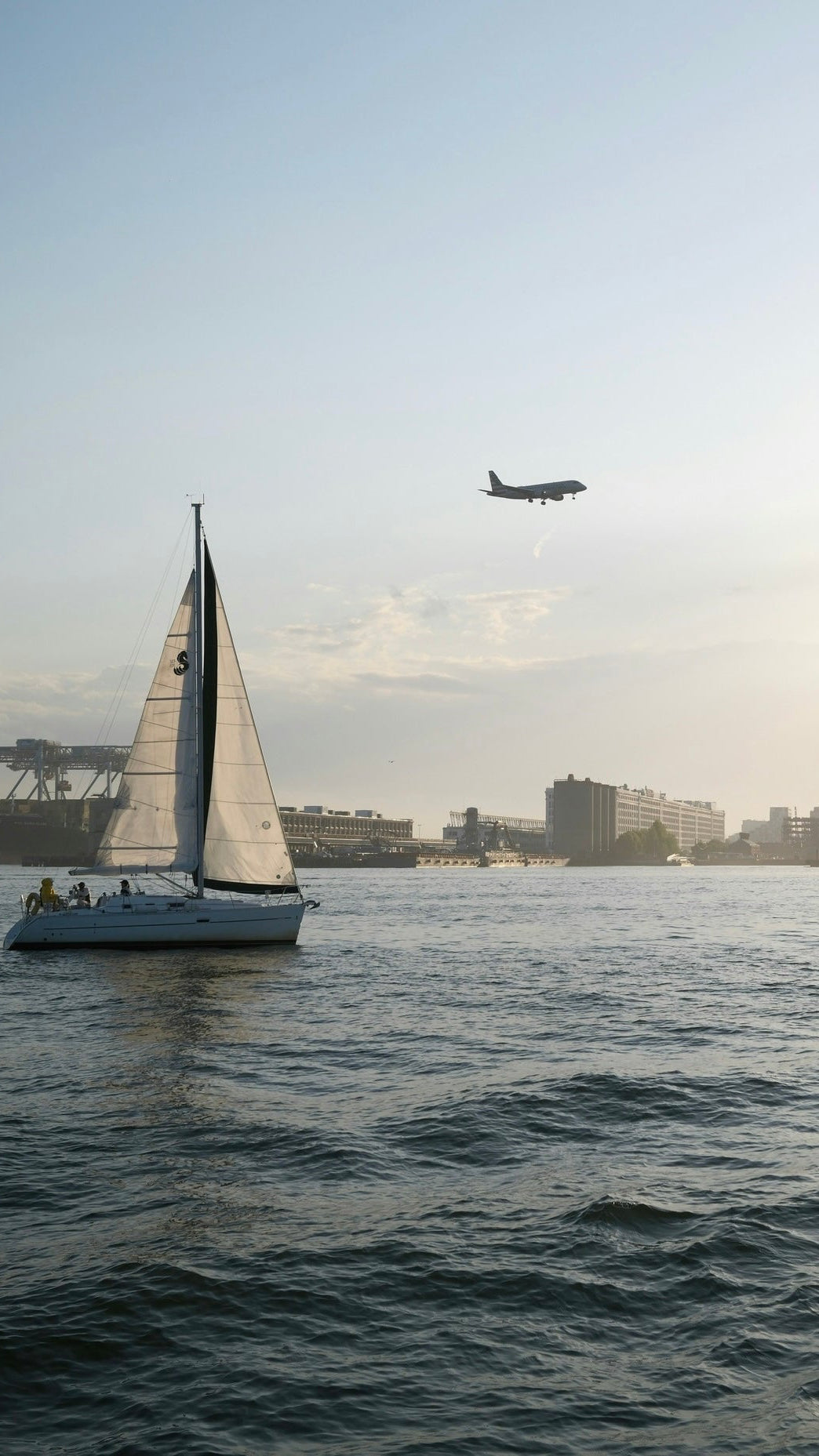 Sailboat on Boston Harbor near the Seaport District at sunset