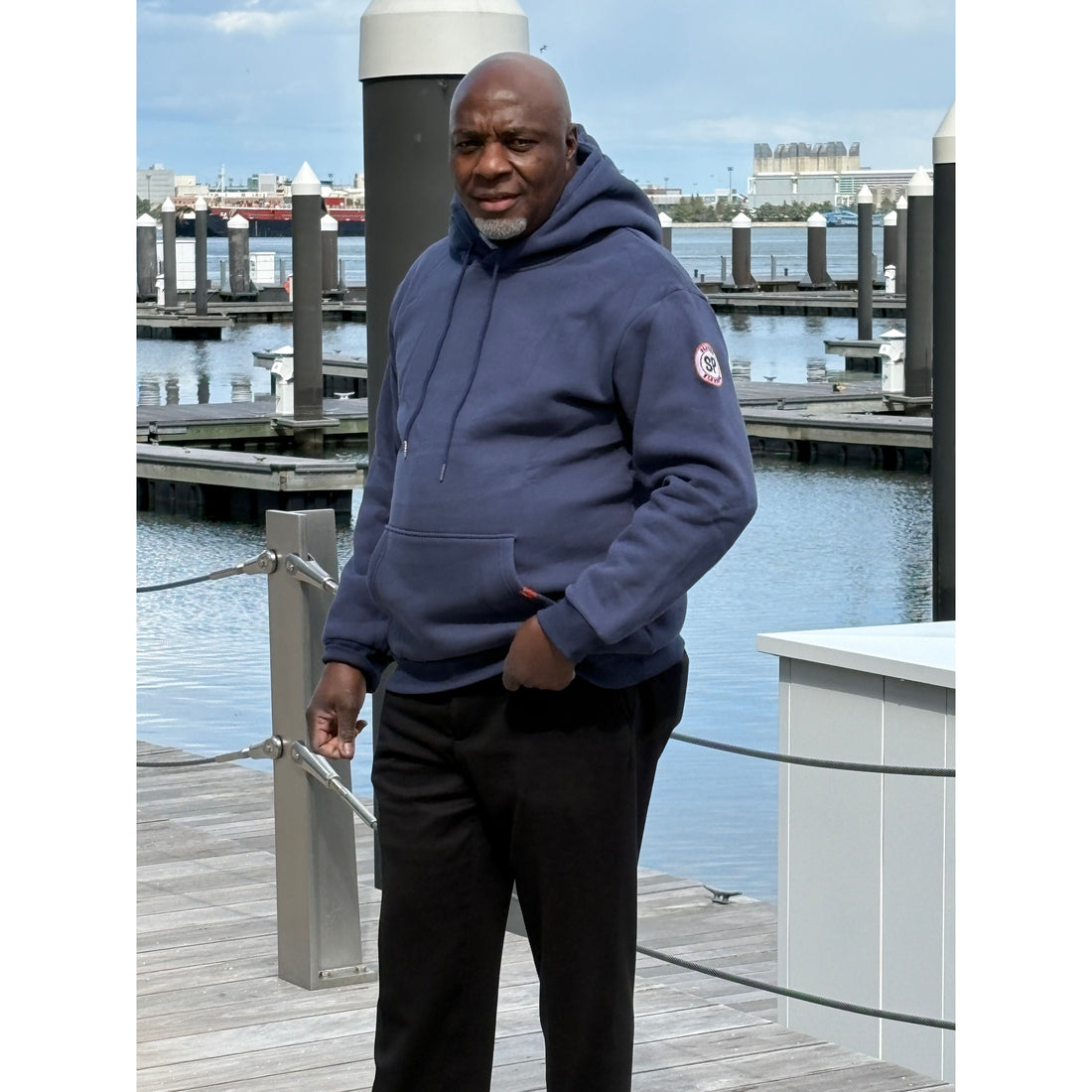 Man standing on the harbor walk in boston