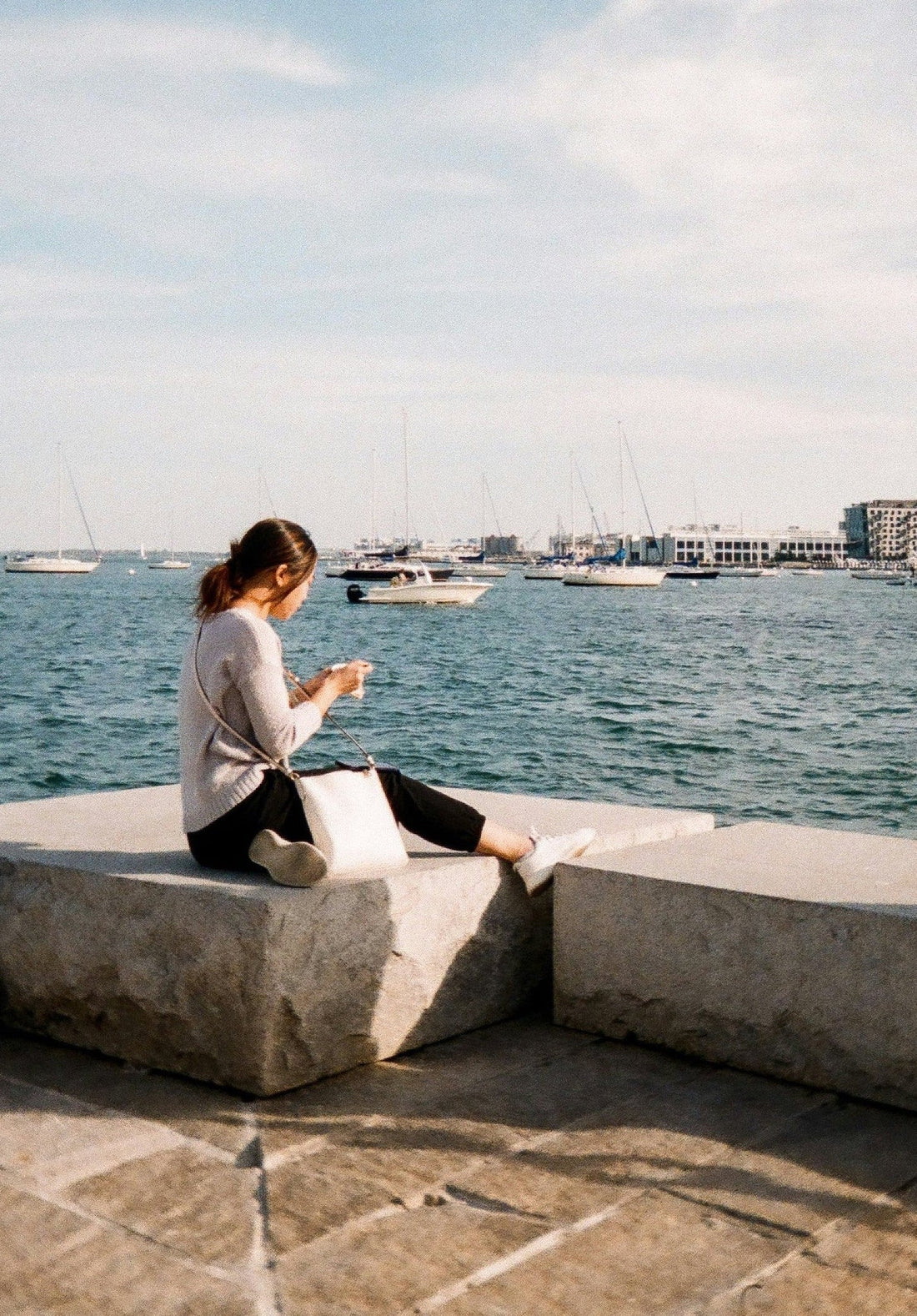 Woman relaxing at Pier 4 in The Seaport District