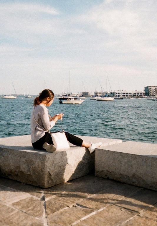 Woman relaxing at Pier 4 in The Seaport District