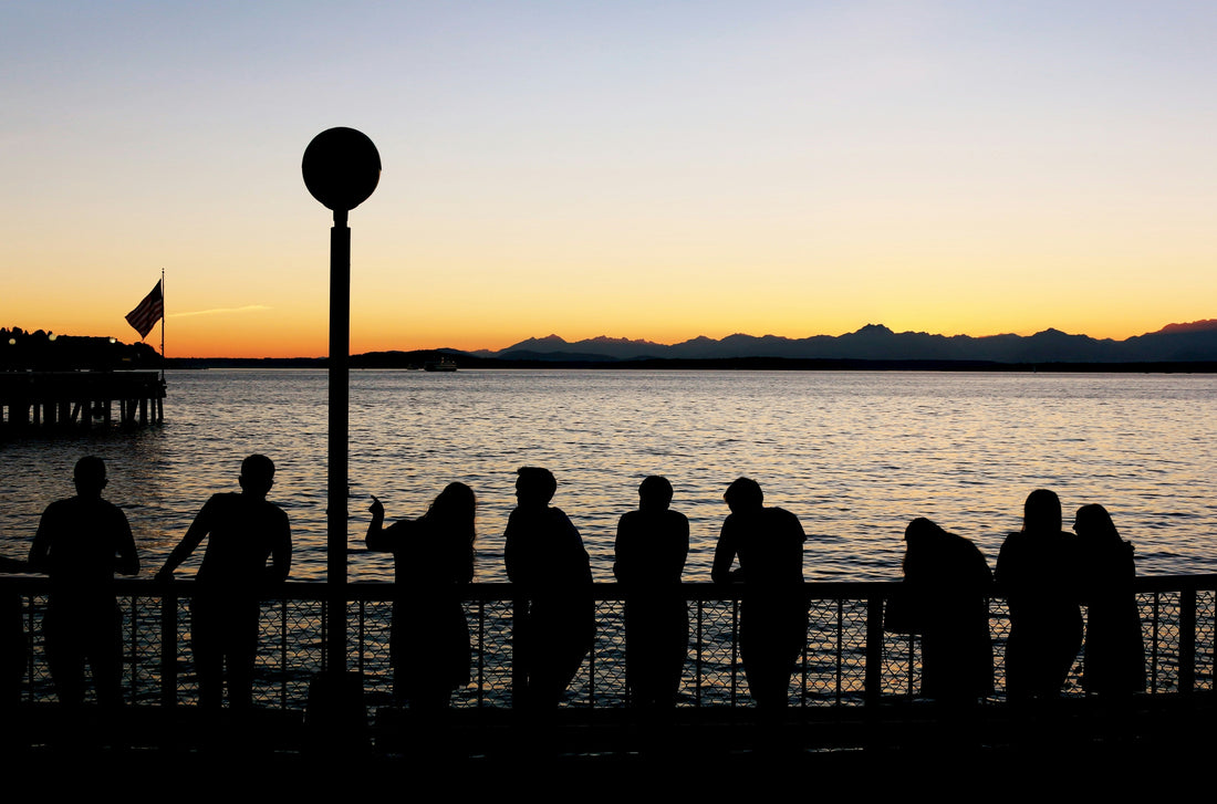 People watching a sunset over the harbor