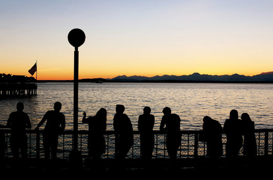 People watching a sunset over the harbor