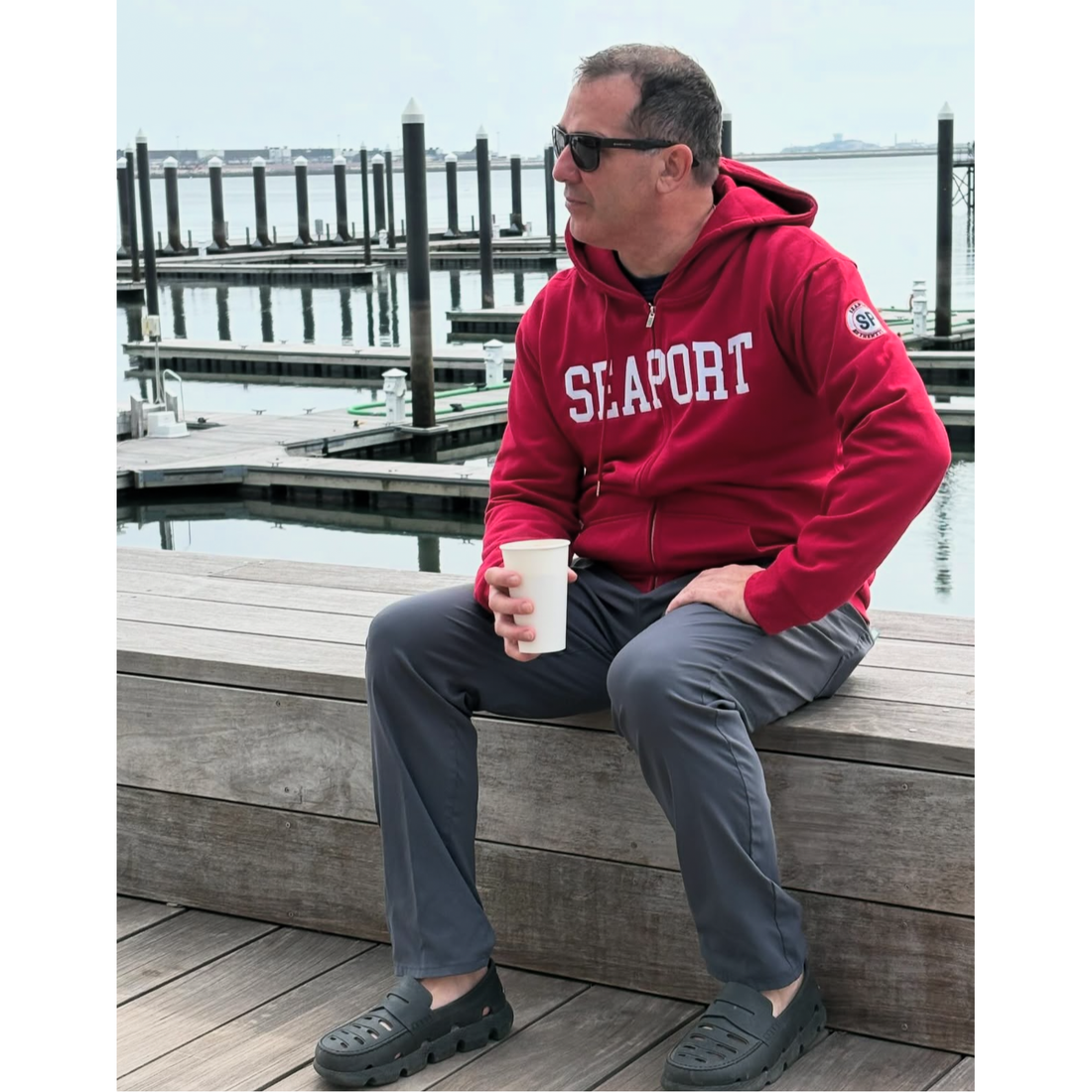 Man sitting at harbor boat marina