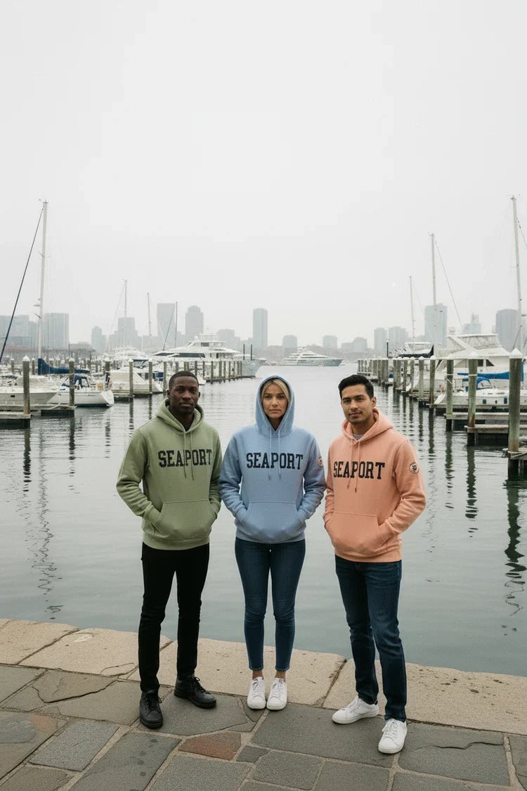 3 people posing in city harbor in heavyweight hoodies