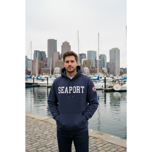 Man wearing navy blue hoodie on harbor