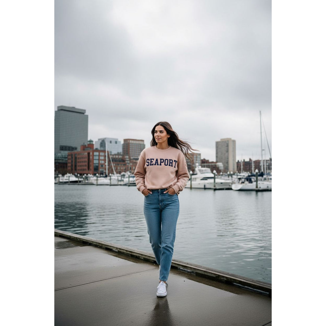 woman wearing pink seaport sweatshirt on harbor