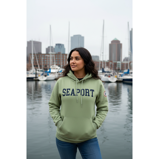 Woman on harbor wearing green hoodie