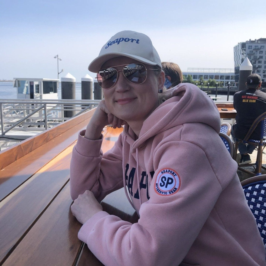 Woman in pink seaport hoodie