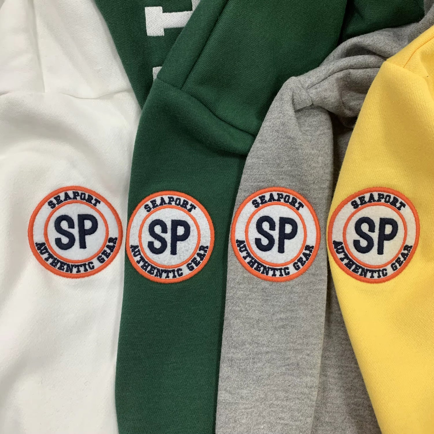 A collection of gift cards from the Seaport brand, displayed on clothing items in different colors.