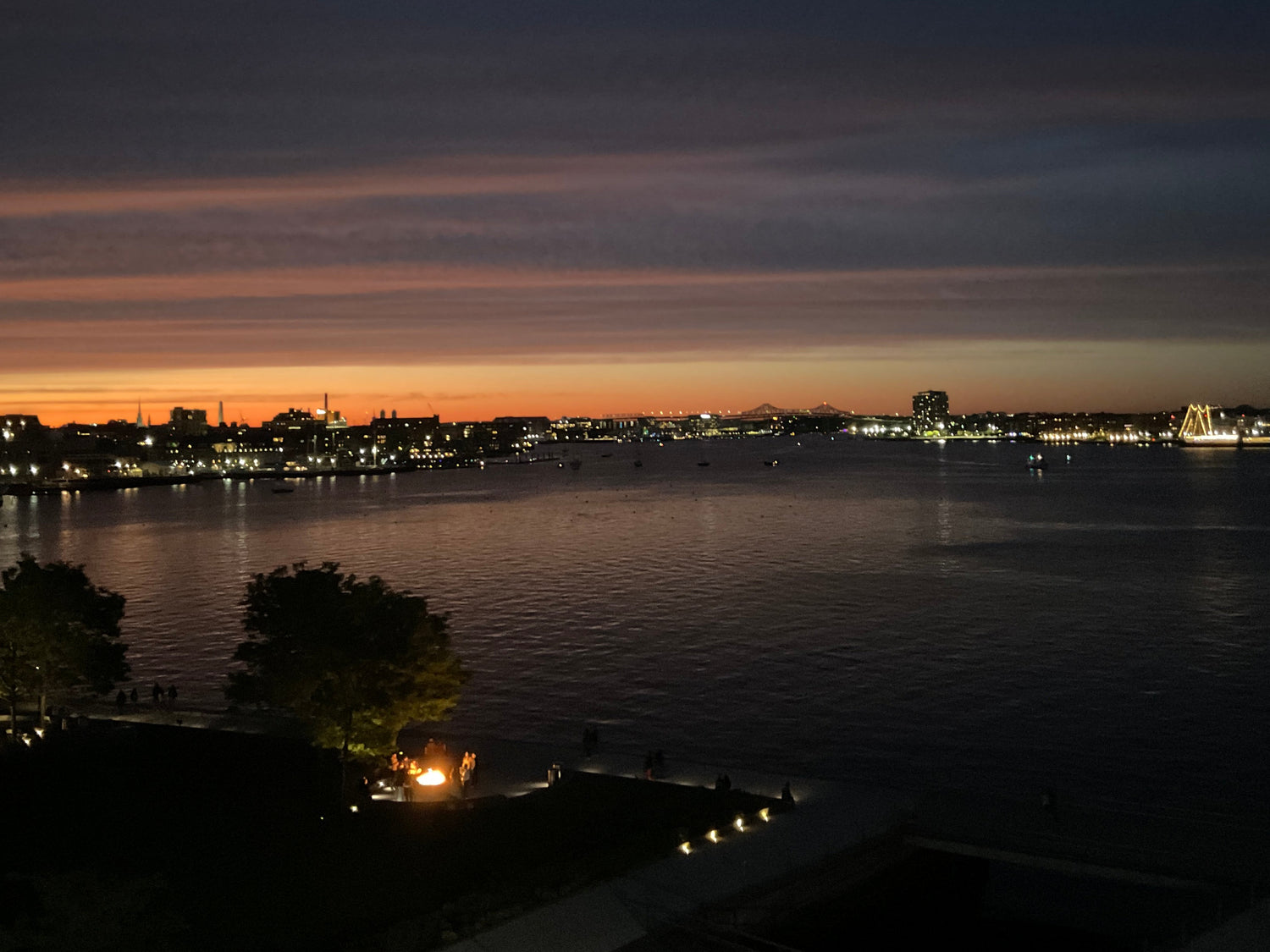 Boston Harbor at night from Seaport with lights reflecting on water