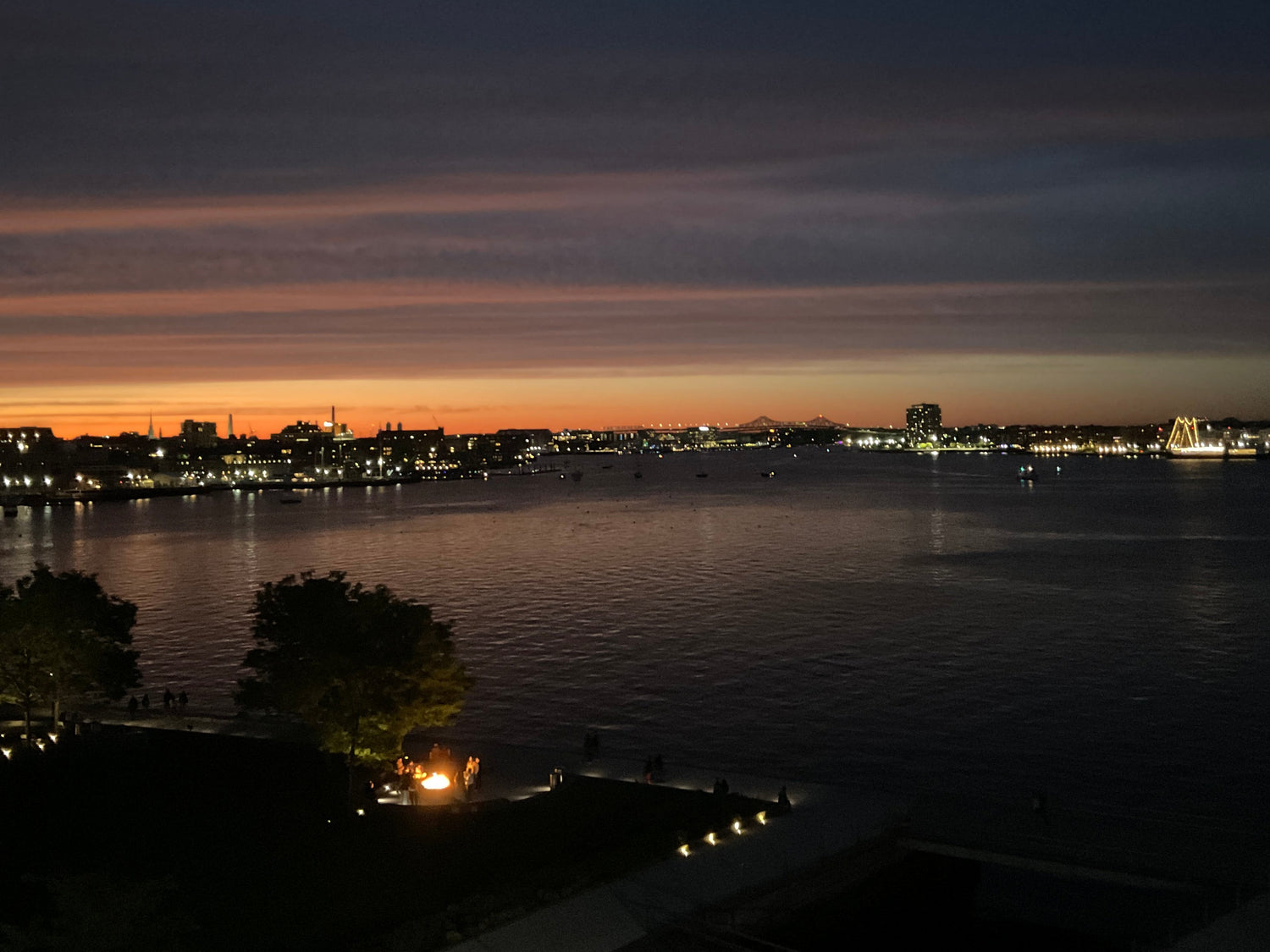 Boston Harbor at night with lights reflecting on water